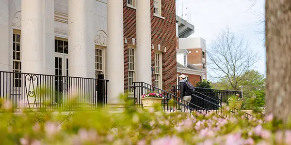 Student walking into a UA building