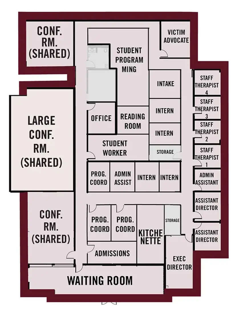 The Camellia Center floor plan is generally rectangular in shape, with a bump‑out on the east side that extends slightly beyond the corners. A block of rooms sits in the center of the floor plan, wrapped by a hallway that connects to additional rooms that line outer perimeter. The north and west walls face the interior of the building, while the east and south walls face outward and include exterior windows.