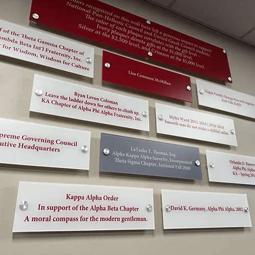 Donor wall plaques on display with some being crimson, white and gray